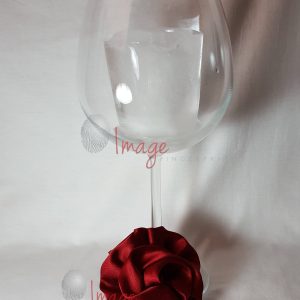 Hair Rosettes 2 or Wineglass with rosette Elegant Wine Glass with Red Satin Hair Rosette – Minimalist Stock Photo