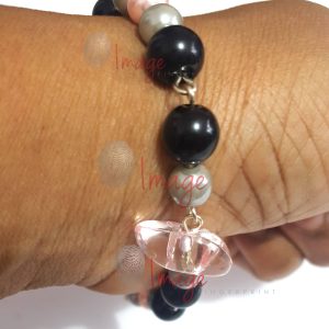 Hand with Pink Bracelet Crop (1) Hand With Wrist Beads - Stock Photo